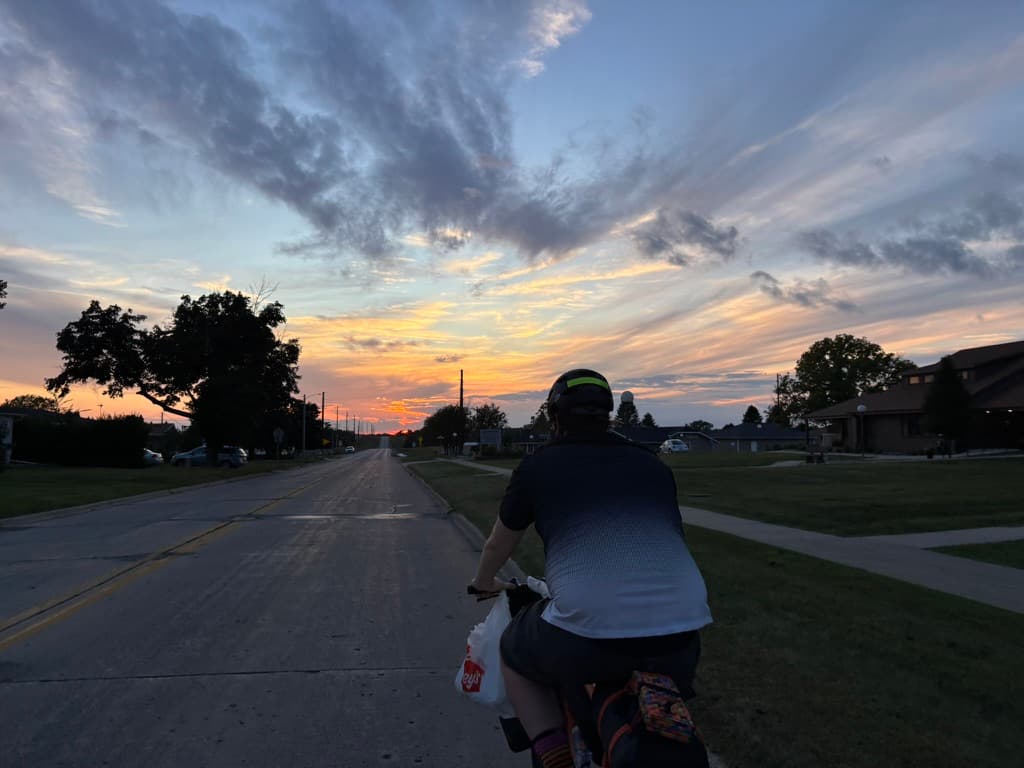 Cyclist riding into sunset